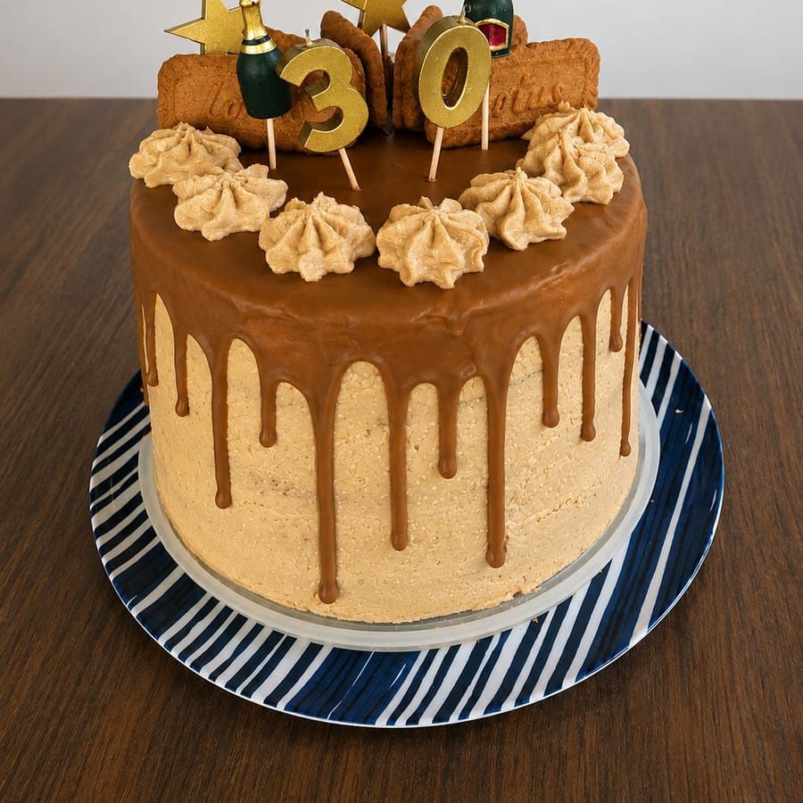 A Biscoff caramel-drip cake topped with ‘30’ candles, gold stars and Biscoff biscuits