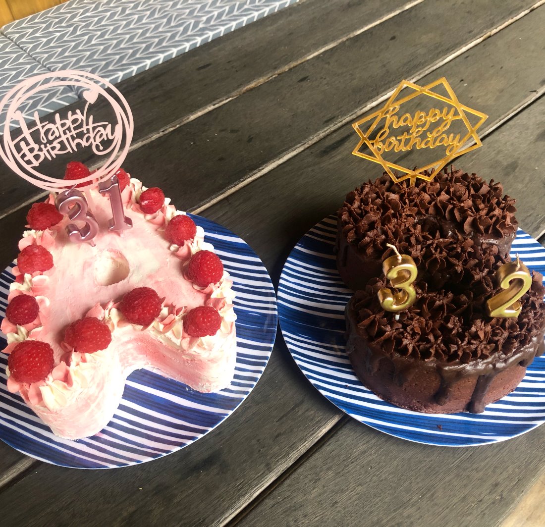 Two number-shaped cakes spelling 31 and 32, decorated with buttercream and toppers
